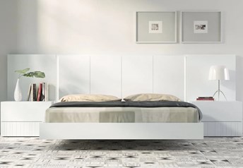 Guardia IRIS floating bed in Alpine White matt lacquer, shown with matching wall panel extensions and bedside tables.