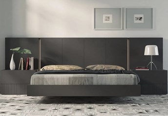 Guardia IRIS floating bed in Anthracite matt lacquer, shown with matching wall panel extensions and bedside tables.