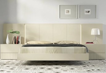 Guardia IRIS floating bed in Arena matt lacquer, shown with matching wall panel extensions and bedside tables.